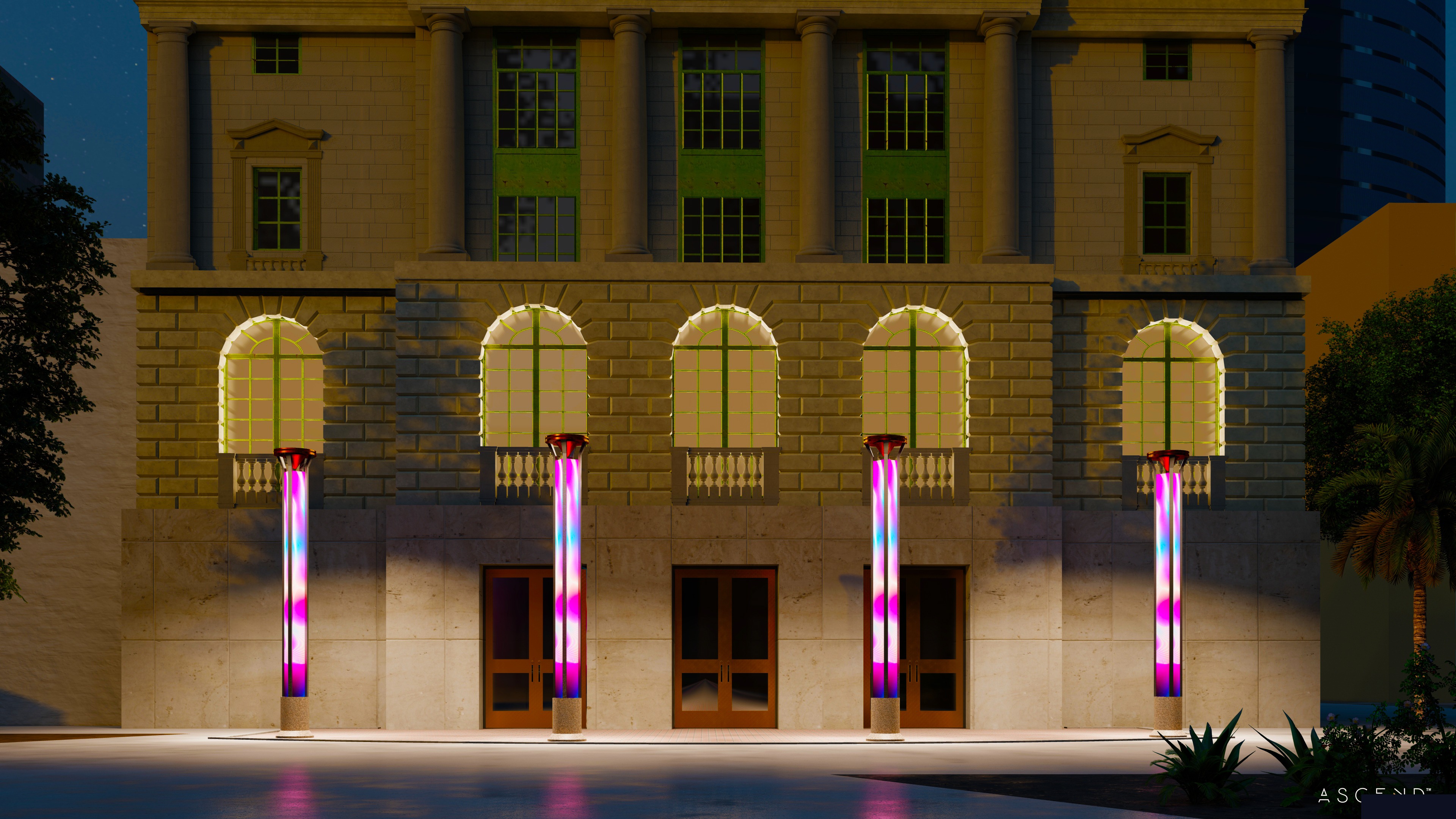 SITE:1023 LED art columns illuminated at night against Heritage Square building