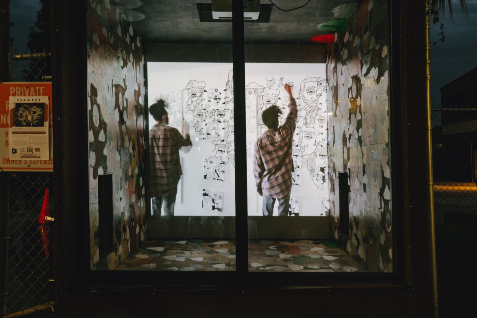 Artist creating live work inside the original ArtCube at night