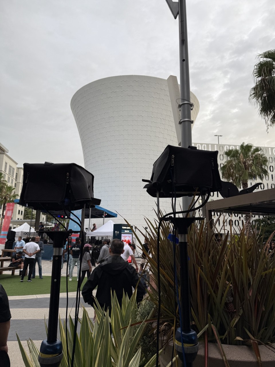 Laser projectors on tripods with the Beacon water tower in the background — daytime setup