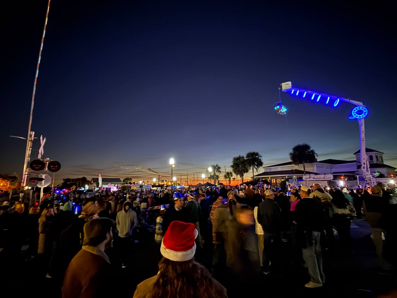 Crowd gathered for the Shrimpy NYE drop with holiday lights