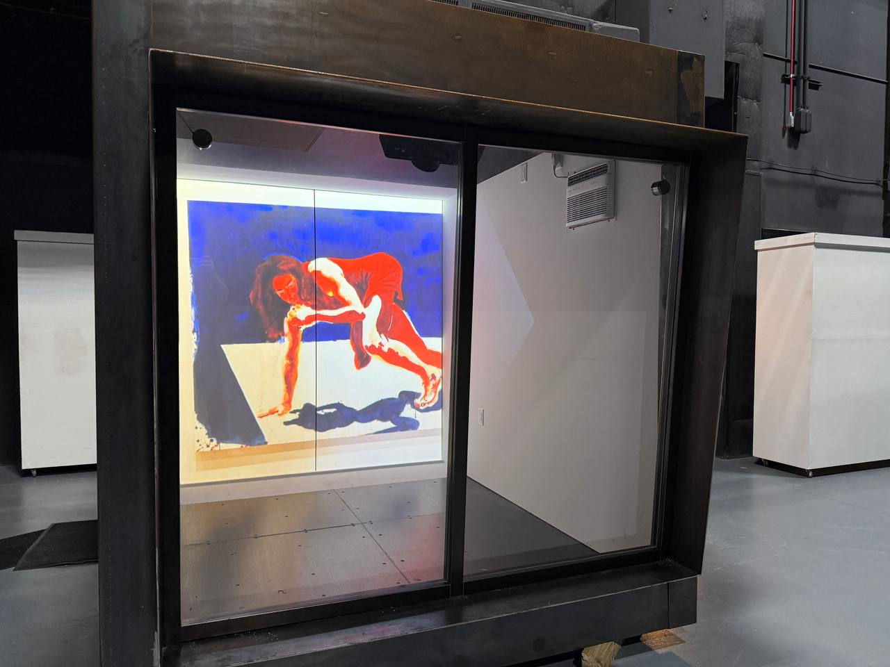 Bold figurative artwork projected inside the UCF ArtCube