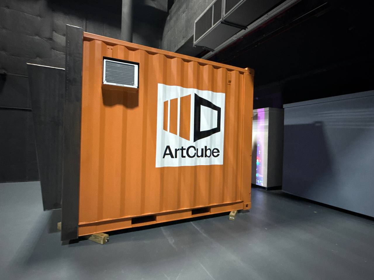 ArtCube doors open, magenta projection flooding the interior