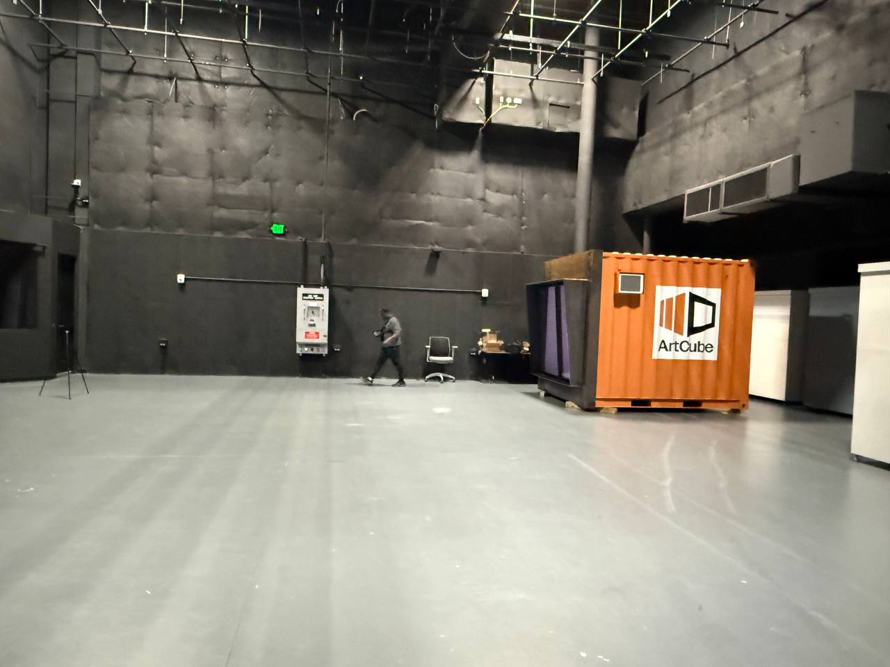 Wide studio shot showing the ArtCube container at scale