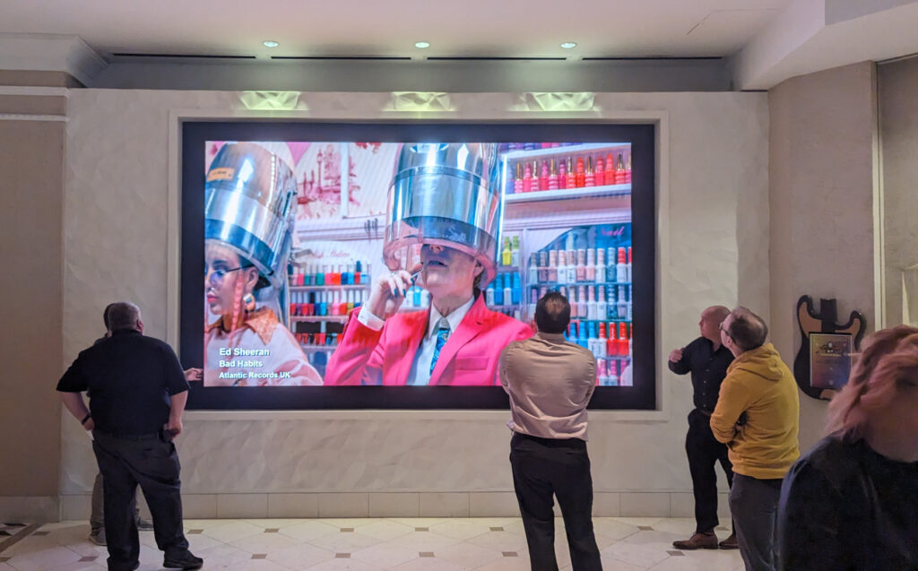 Lobby LED wall โ Ed Sheeran music video playing